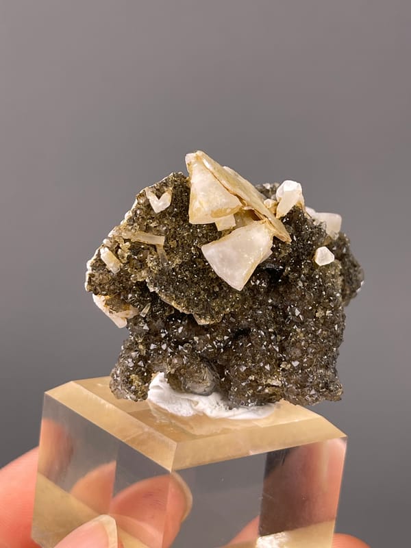 Quartz natural specimen highlighting cream crystals over dark sulfides clearly