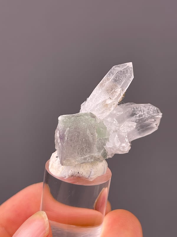 Clear quartz over green-gray fluorite visible on quartz specimen from Longyan, Fujian, China
