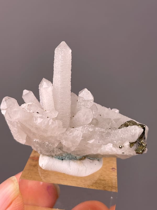 Quartz specimen from Longyan, Fujian, China featuring white quartz cluster with brassy crystals