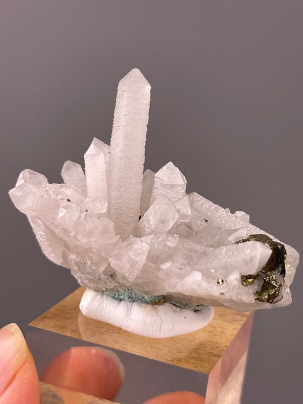 Quartz specimen from Longyan, Fujian, China showing white quartz cluster with brassy crystals
