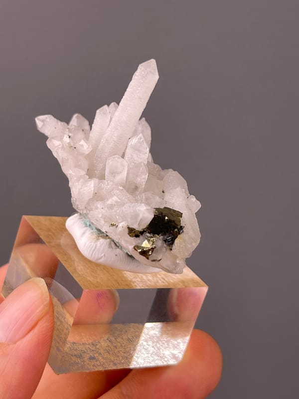Quartz specimen from Longyan, Fujian, China, defined by white quartz cluster with brassy crystals