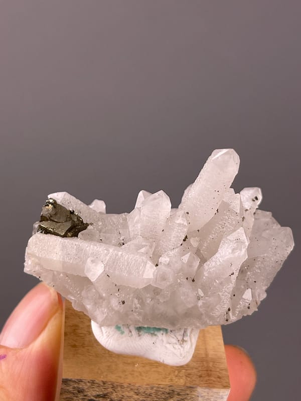 Quartz specimen from Longyan, Fujian, China presenting white quartz cluster with brassy crystals