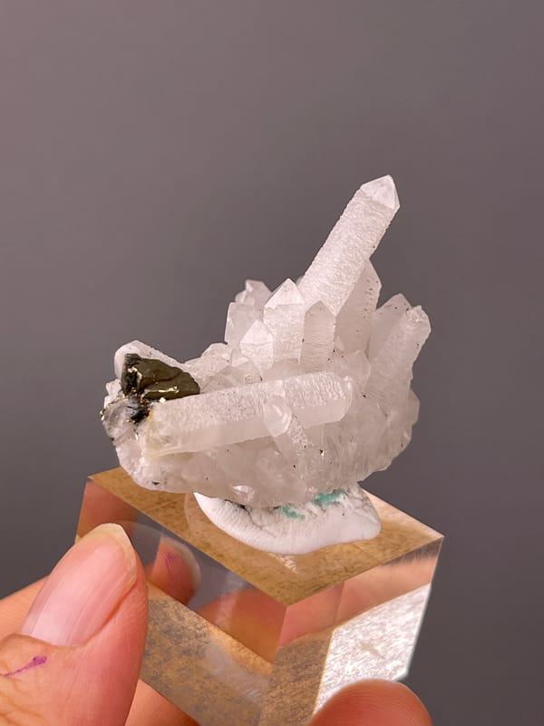 Quartz specimen from Longyan, Fujian, China displaying white quartz cluster with brassy crystals