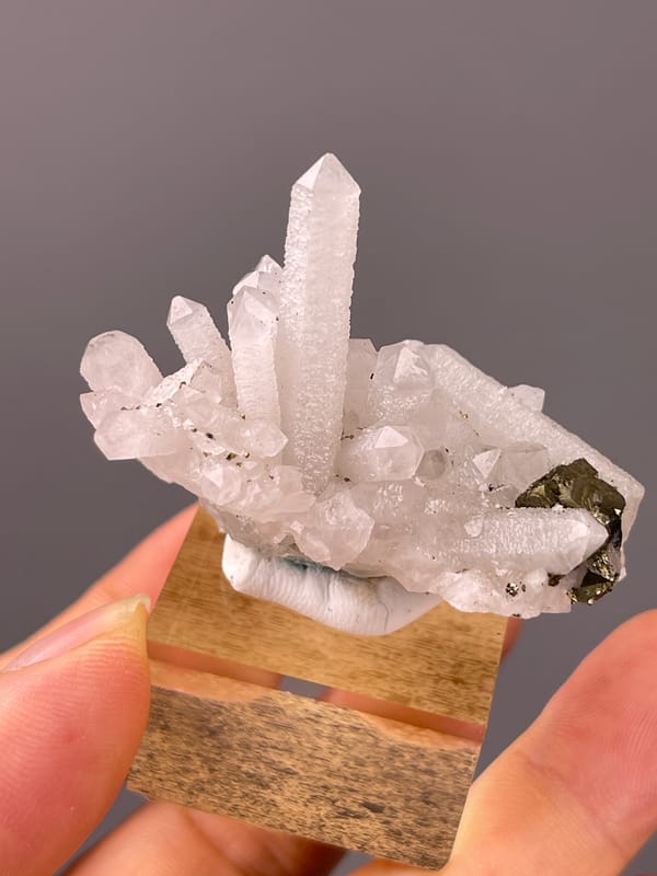 Quartz specimen from Longyan, Fujian, China highlighting white quartz cluster with brassy crystals