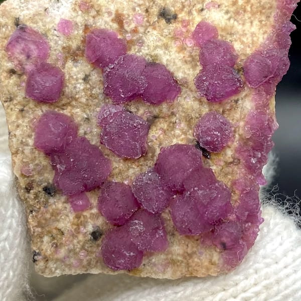 Raspberry-purple fluorite octahedra on pale plate from Henan, China, view 3 of 9