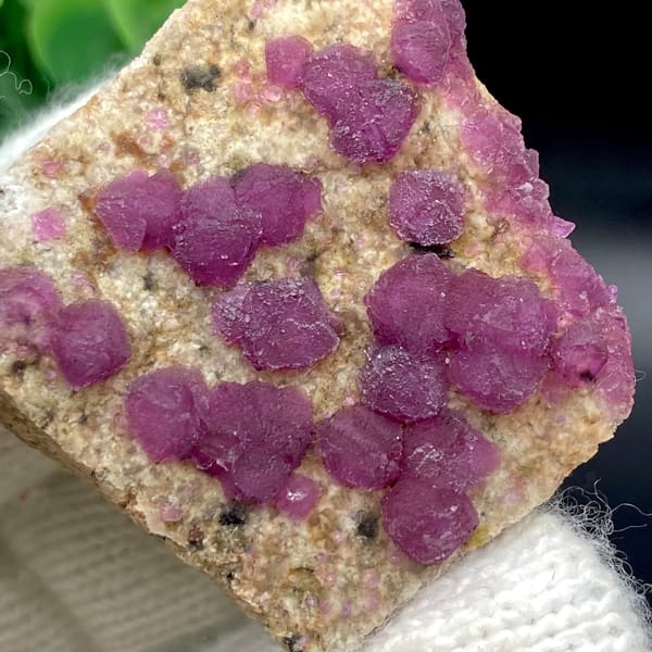 Raspberry-purple fluorite octahedra on pale plate from Henan, China, view 7 of 9