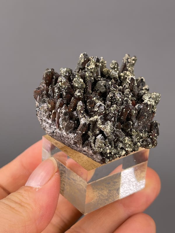 Dark quartz prisms with brassy pyrite visible on red quartz specimen from Xianghualing, Hunan, China