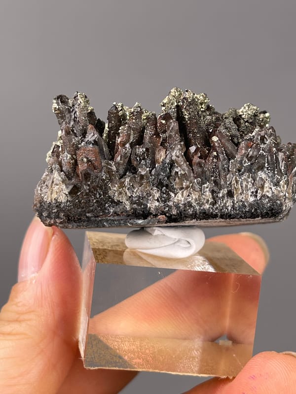 Dark quartz prisms with brassy pyrite on natural red quartz specimen from Xianghualing, Hunan, China