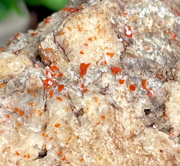 Red wulfenite spots over pale matrix block from Sichuan, China, view 2 of 9