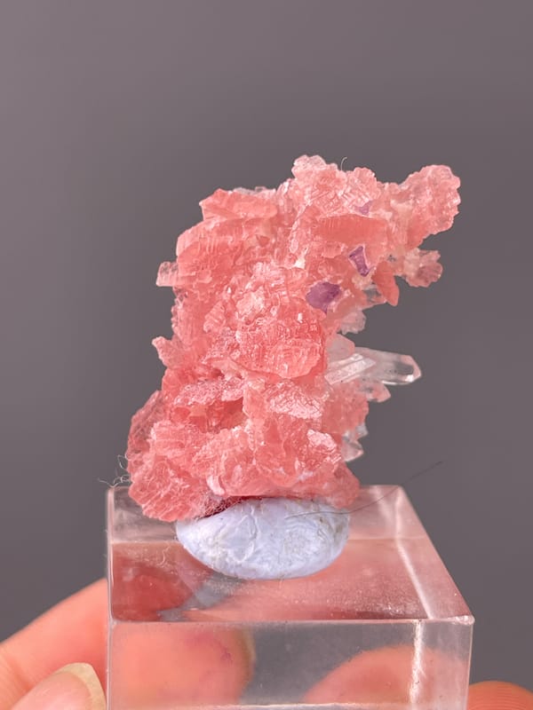 Rhodochrosite specimen from Guangxi, China showing pink carbonate cluster with clear quartz