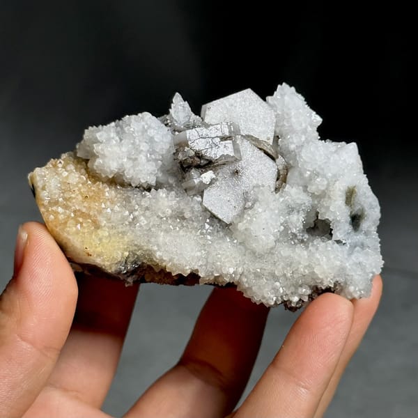 Hexagonal sandwich calcite plates on yellow-stained quartz from Fujian, China, view 10 of 11