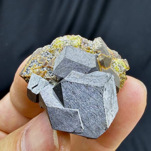 Large grey magnetite crystal on garnet and calcite from Inner Mongolia, China, view 2 of 6