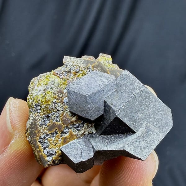 Large grey magnetite crystal on garnet and calcite from Inner Mongolia, China, view 3 of 6