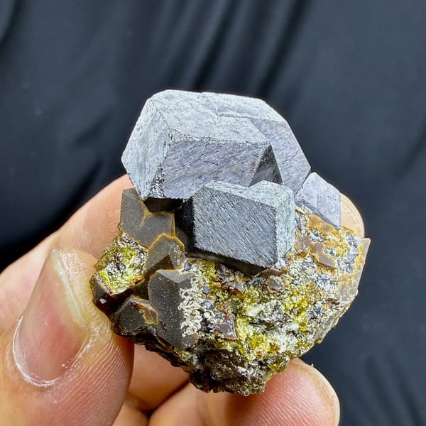 Large grey magnetite crystal on garnet and calcite from Inner Mongolia, China, view 4 of 6