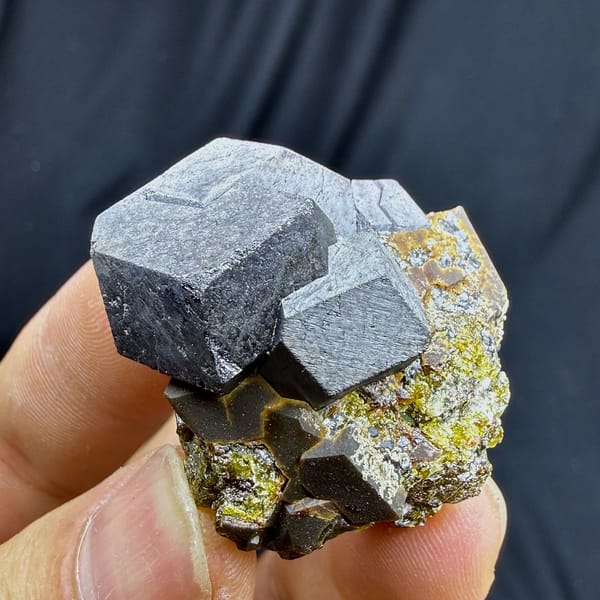 Large grey magnetite crystal on garnet and calcite from Inner Mongolia, China, view 5 of 6