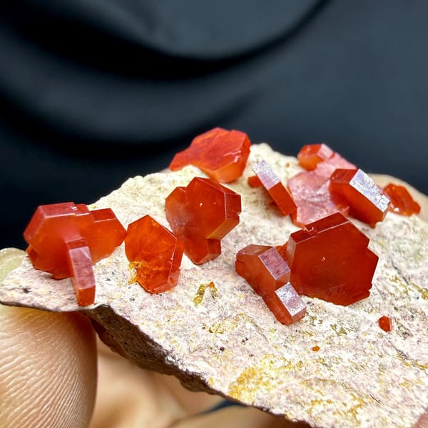 Scarlet vanadinite crystals scattered on pale matrix from Morocco, view 2 of 6