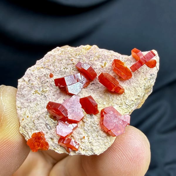 Scarlet vanadinite crystals scattered on pale matrix from Morocco, view 5 of 6