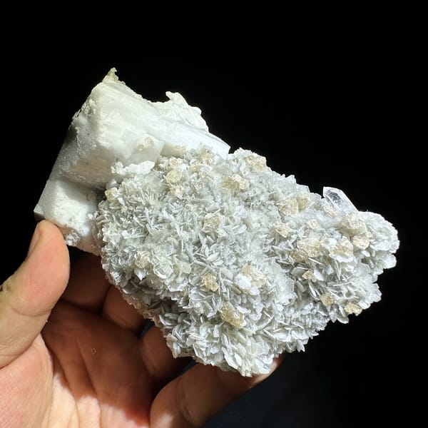 Large feldspar crystal with scheelite, aquamarine and muscovite from Xuebaoding, Sichuan, close-up of the crystal faces