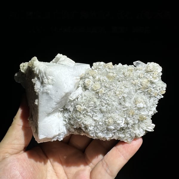 Large feldspar crystal with scheelite, aquamarine and muscovite from Xuebaoding, Sichuan, China, detail of the matrix contact