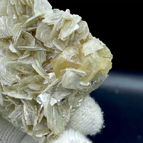 Honey scheelite crystal on silvery mica blades from Sichuan, China, view 5 of 9