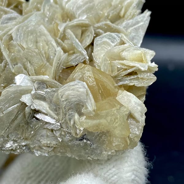 Honey scheelite crystal on silvery mica blades from Sichuan, China, view 8 of 9