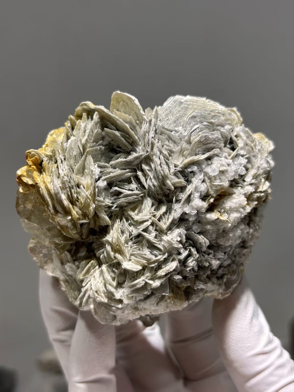 Cluster of silvery mica rosettes with aquamarine from Xuebaoding, Sichuan, China