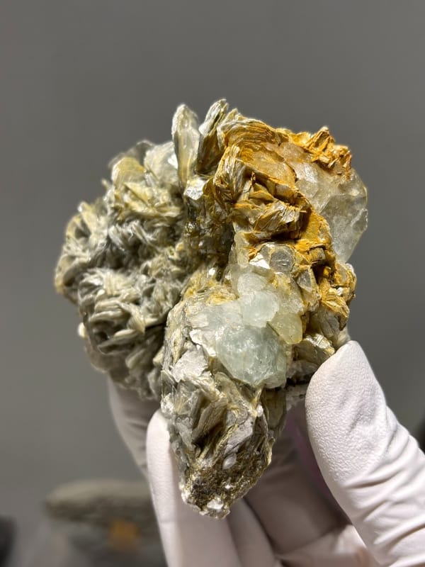 Cluster of silvery mica rosettes with aquamarine from Xuebaoding, Sichuan, China, view 3 of 5