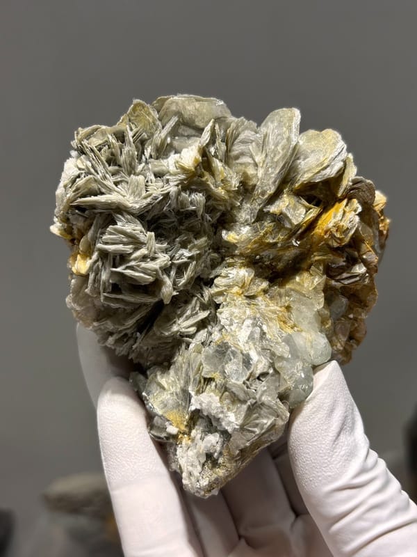 Cluster of silvery mica rosettes with aquamarine from Xuebaoding, Sichuan, China, view 4 of 5
