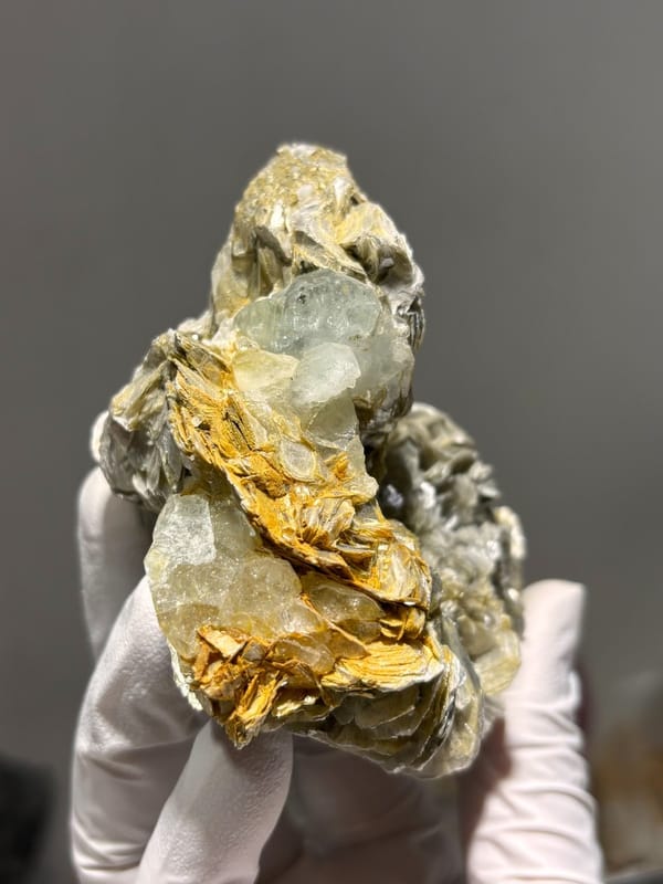 Cluster of silvery mica rosettes with aquamarine from Xuebaoding, Sichuan, China, view 5 of 5