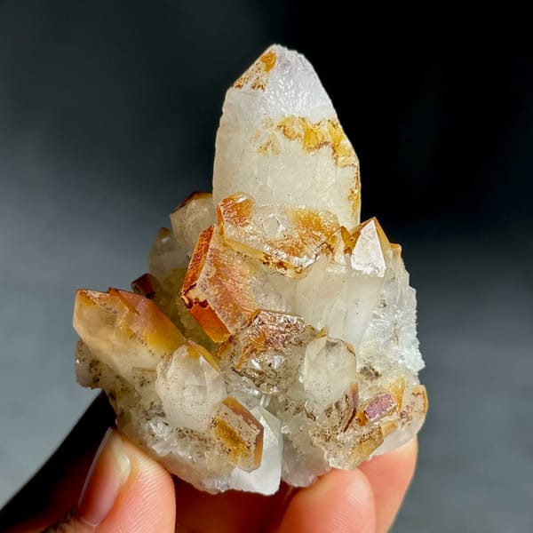 Orange-skinned calcite crystals with clear quartz points from Fujian, China, view 2 of 13