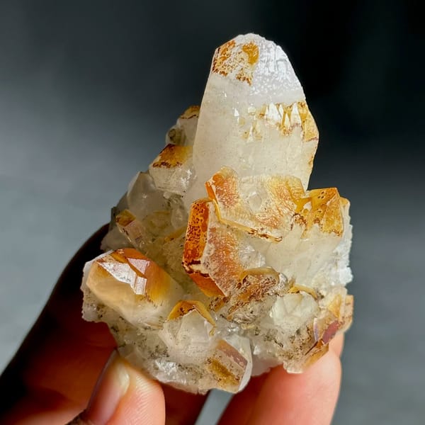Orange-skinned calcite crystals with clear quartz points from Fujian, China, view 4 of 13