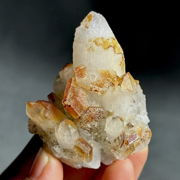 Orange-skinned calcite crystals with clear quartz points from Fujian, China, view 8 of 13