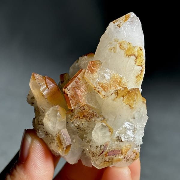Orange-skinned calcite crystals with clear quartz points from Fujian, China, view 10 of 13