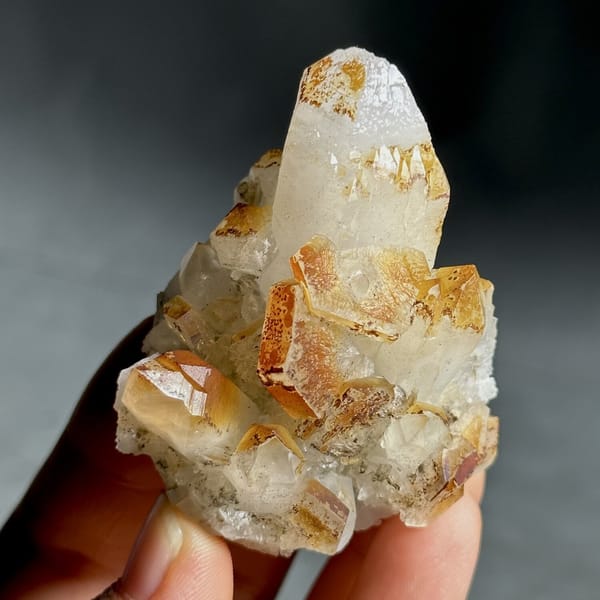 Orange-skinned calcite crystals with clear quartz points from Fujian, China, view 11 of 13