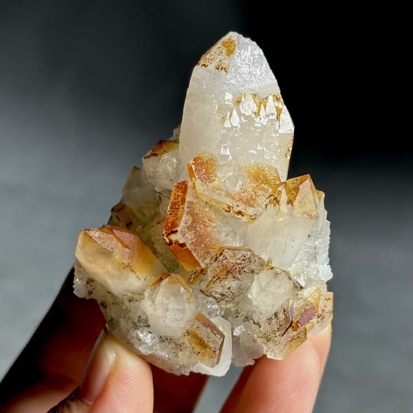 Orange-skinned calcite crystals with clear quartz points from Fujian, China, view 12 of 13