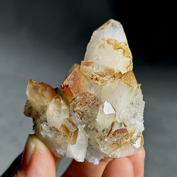 Orange-skinned calcite crystals with clear quartz points from Fujian, China, view 13 of 13