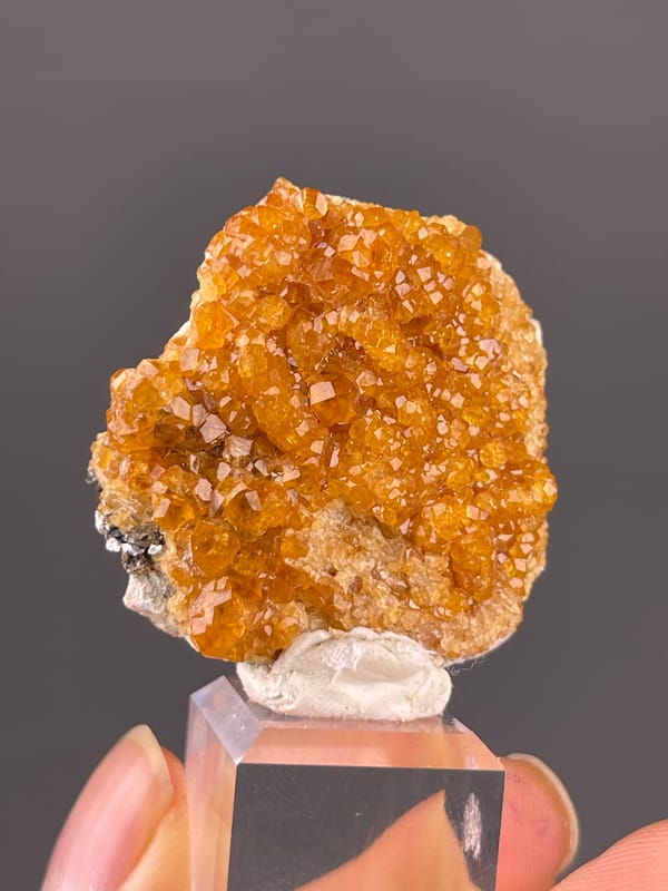 Orange-brown crystal druse on natural spessartine garnet specimen from Yunxiao, Fujian, China