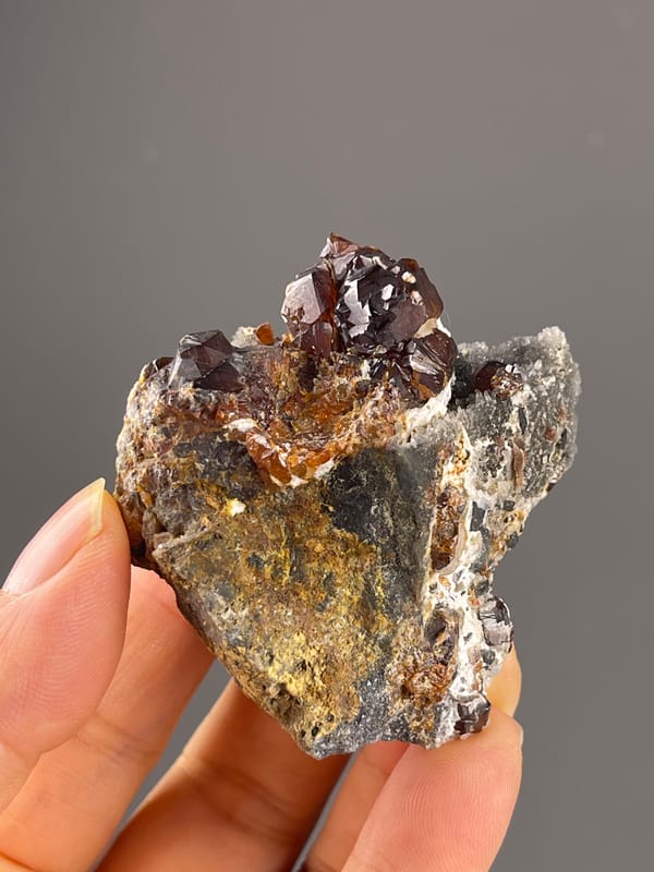 Reddish-brown resinous crystals on natural sphalerite specimen from Hunan, China