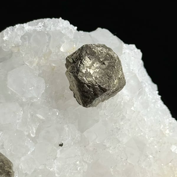 Three ball-shaped pyrite crystals on white quartz plate from Guangxi, China, view 3 of 12