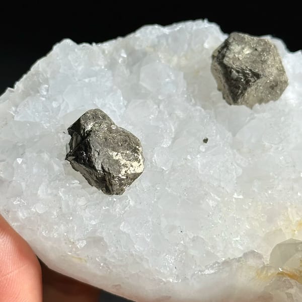 Three ball-shaped pyrite crystals on white quartz plate from Guangxi, China, view 4 of 12
