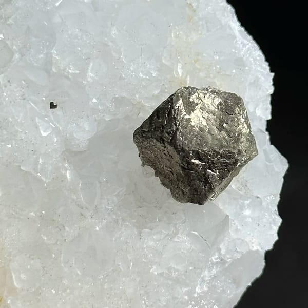 Three ball-shaped pyrite crystals on white quartz plate from Guangxi, China, view 5 of 12