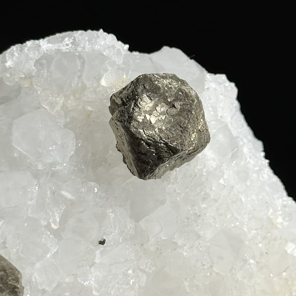 Three ball-shaped pyrite crystals on white quartz plate from Guangxi, China, view 10 of 12