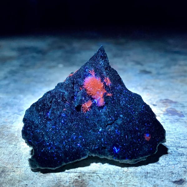 Fuzzy yellow stibiconite ball on black matrix from Hunan, China, view 2 of 6