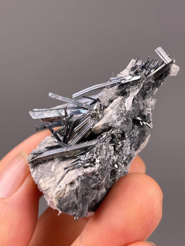 Steel-gray striated radiating blades on natural Stibnite with Calcite specimen from Lengshuijiang, Hunan, China