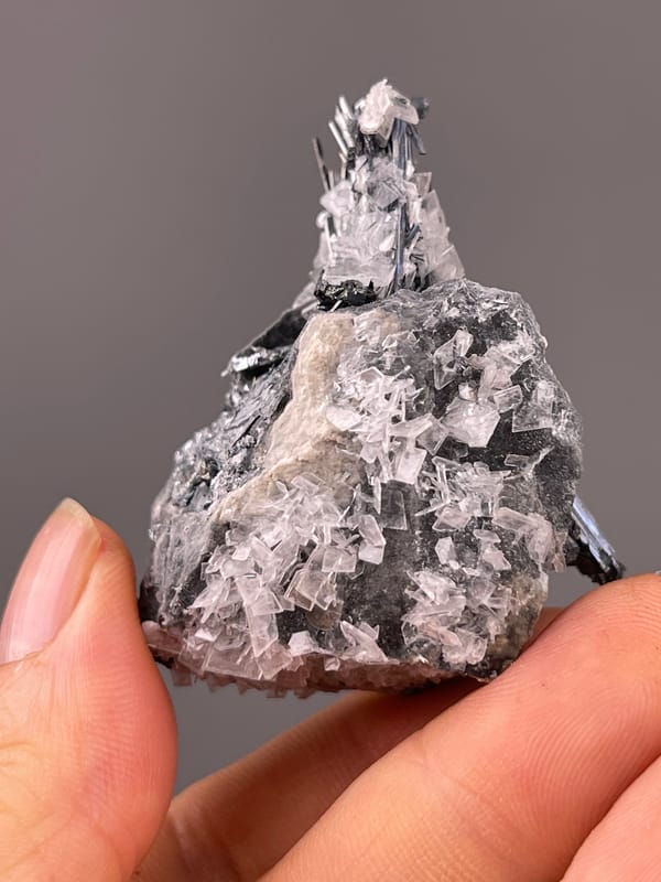 Stibnite with Calcite specimen from Lengshuijiang, Hunan, China bearing steel-gray striated radiating blades