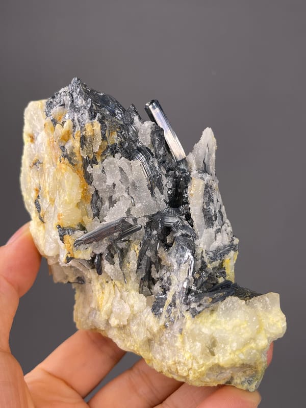 Steel-gray blades with pale crystals on natural stibnite specimen from Lengshuijiang, Hunan, China