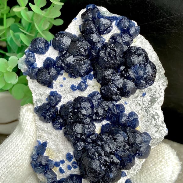 Navy-blue strawberry quartz balls on pale plate from Inner Mongolia, China, view 3 of 9