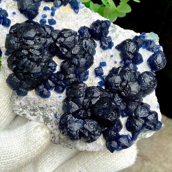 Navy-blue strawberry quartz balls on pale plate from Inner Mongolia, China, view 4 of 9