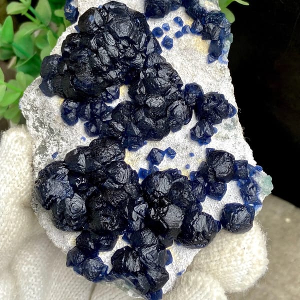 Navy-blue strawberry quartz balls on pale plate from Inner Mongolia, China, view 5 of 9