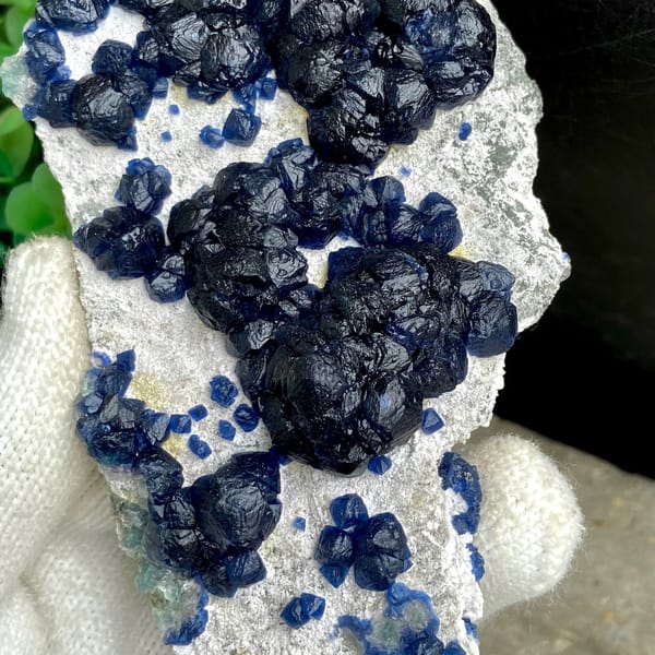 Navy-blue strawberry quartz balls on pale plate from Inner Mongolia, China, view 6 of 9
